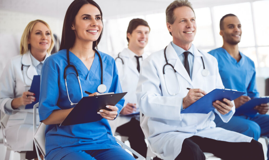 Successful,Medical,Doctors,Are,Making,Notes,And,Smiling,While,Sitting